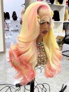 Blonde and pink ombre 13x4 HD lace frontal wig made with 100% raw virgin human hair, soft, silky, and full-bodied with glamorous curls.