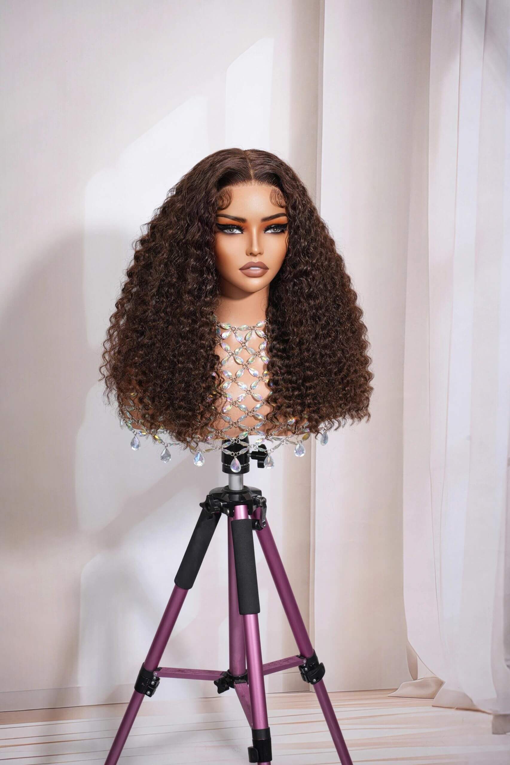 A voluminous kinky curly lace wig in natural brown, available in 5x5 closure and 13x4 lace front, 100% virgin human hair