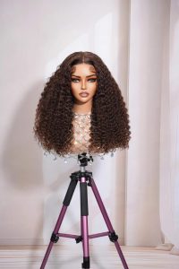 Mannequin wearing a long kinky curly human hair lace wig, natural brown color, 5x5 closure or 13x4 HD lace front option, 100% virgin hair