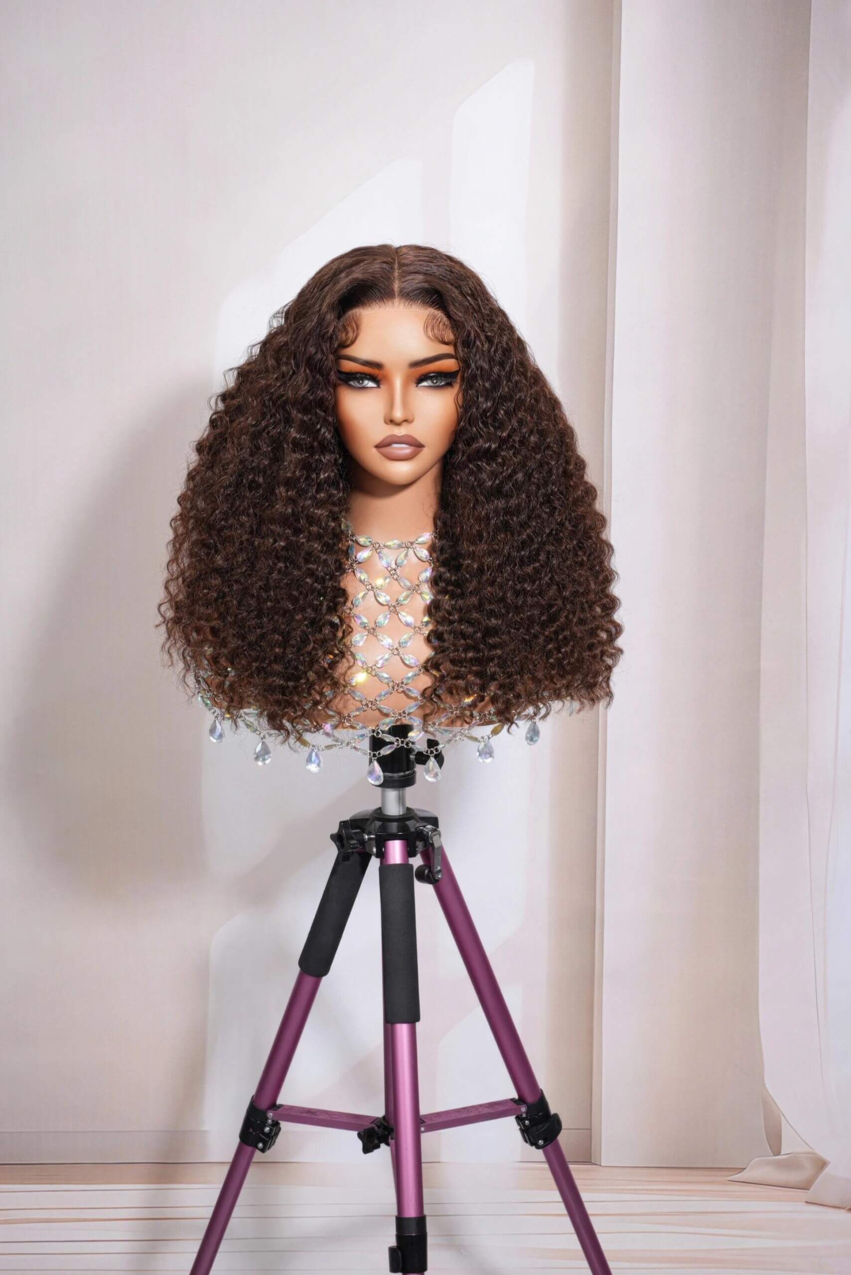 Mannequin wearing a long kinky curly human hair lace wig, natural brown color, 5x5 closure or 13x4 HD lace front option, 100% virgin hair