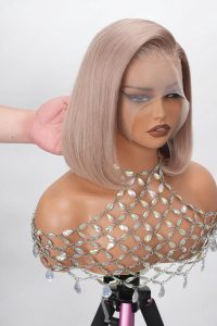 Mannequin wearing a short ash blonde straight bob lace front wig with 13x4 HD transparent lace