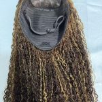 Mannequin head wearing a long curly lace front wig with brown and blonde highlights, 100% virgin human hair, 13x4 HD lace, natural pre-plucked hairline.